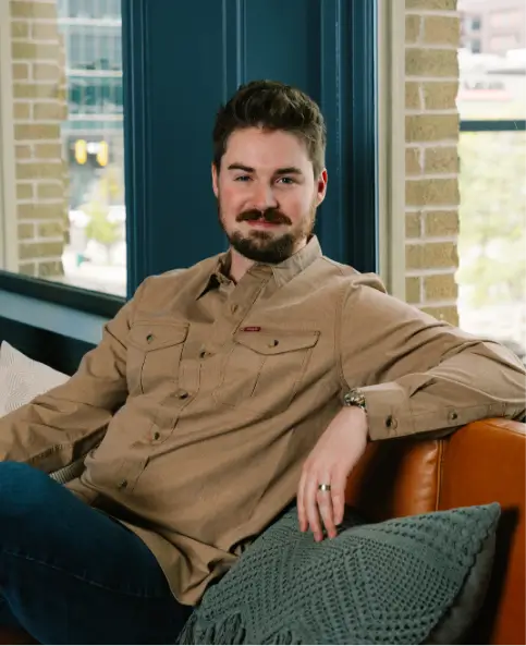 behind the scenes of arctic marketing Kason sitting on a couch